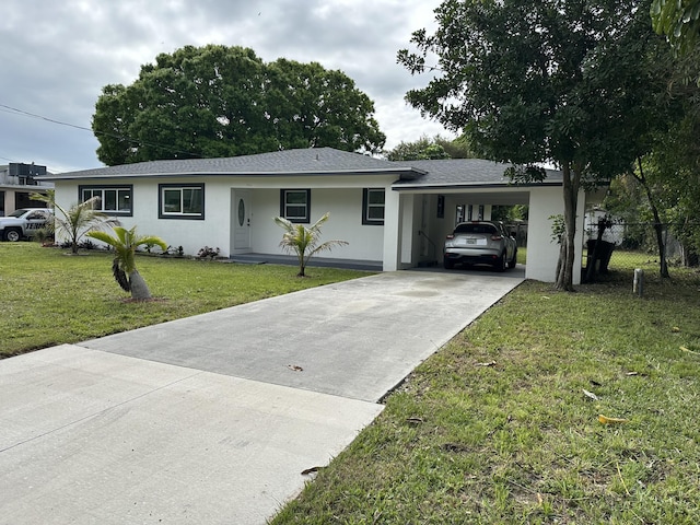 ranch-style house featuring stucco siding, fence, an attached carport, driveway, and a front lawn