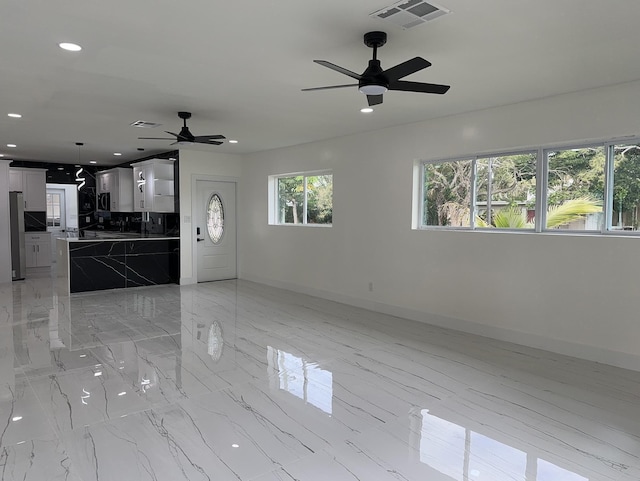 unfurnished living room featuring recessed lighting, marble finish floor, visible vents, and baseboards