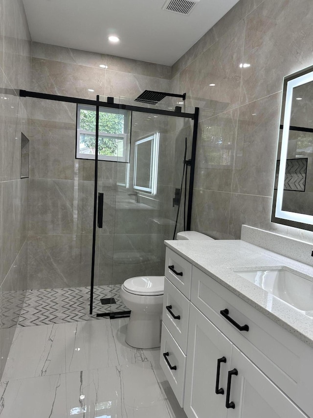 full bath featuring marble finish floor, a shower stall, toilet, and vanity