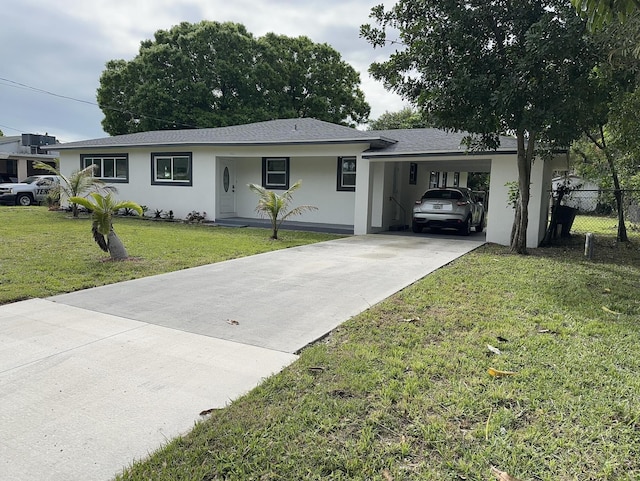 single story home with stucco siding, fence, an attached carport, driveway, and a front lawn