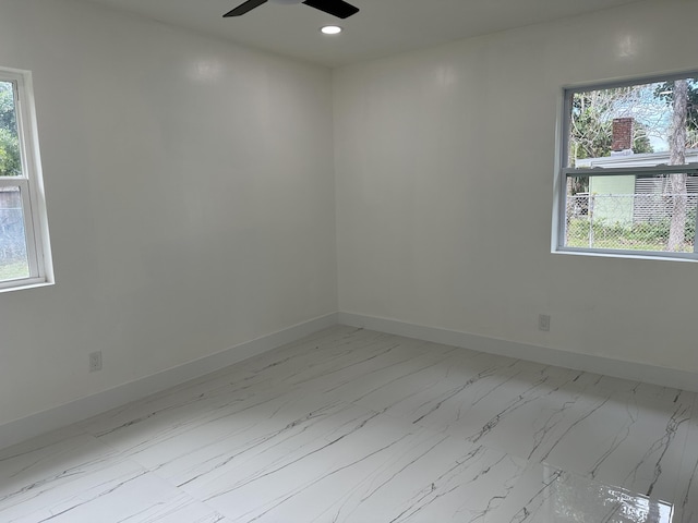 unfurnished room featuring ceiling fan, marble finish floor, recessed lighting, and baseboards