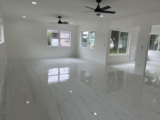 unfurnished room featuring marble finish floor, ceiling fan, baseboards, and recessed lighting