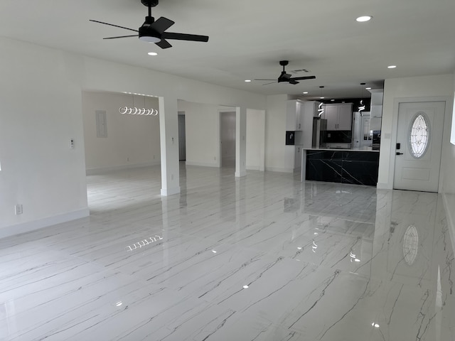 unfurnished living room featuring marble finish floor, ceiling fan, baseboards, and recessed lighting