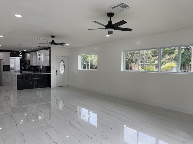 spare room with baseboards, marble finish floor, visible vents, and recessed lighting