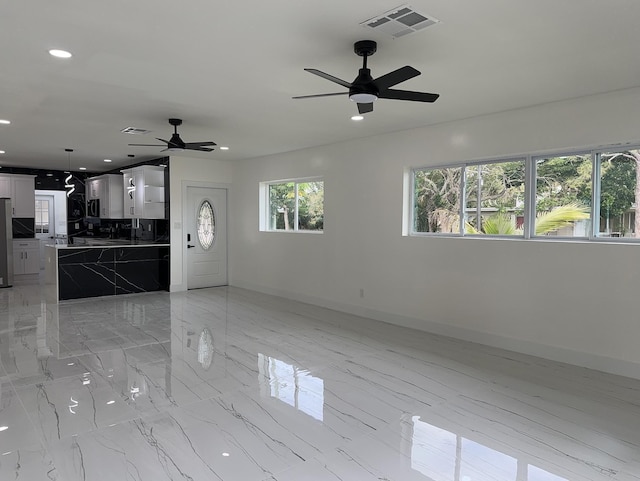 unfurnished living room featuring marble finish floor, baseboards, visible vents, and recessed lighting