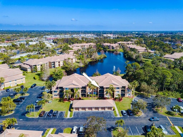 birds eye view of property with a water view and a residential view