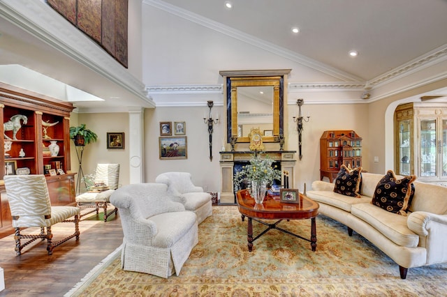 living room with ornamental molding, high vaulted ceiling, and wood finished floors