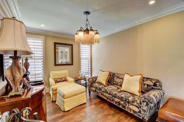 living area with ornamental molding, recessed lighting, an inviting chandelier, and wood finished floors