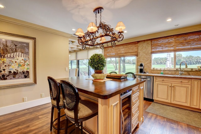 kitchen featuring beverage cooler, dark wood-type flooring, a sink, ornamental molding, and dishwasher