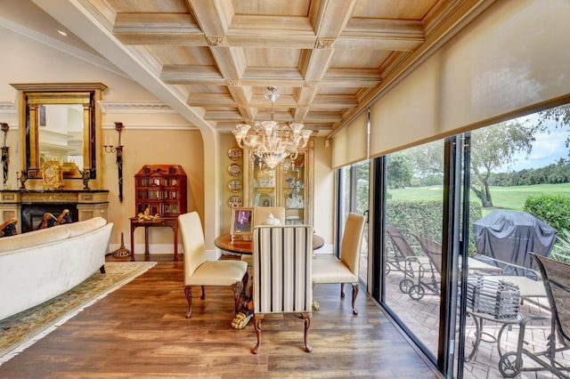 dining area featuring crown molding, coffered ceiling, wood finished floors, and an inviting chandelier