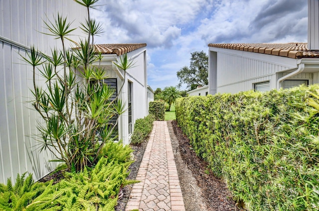 view of side of home featuring a tile roof