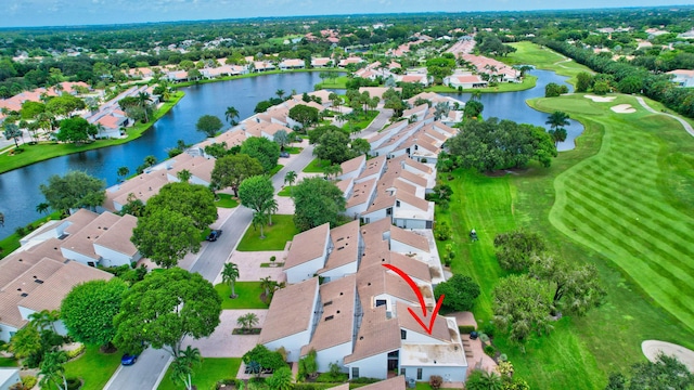 birds eye view of property with a water view, a residential view, and golf course view