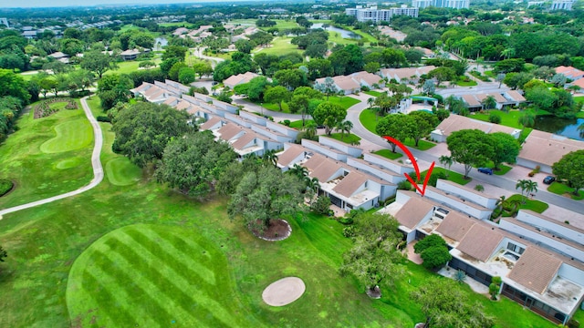 drone / aerial view featuring view of golf course and a residential view