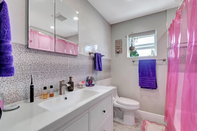 bathroom with tasteful backsplash, visible vents, toilet, vanity, and baseboards