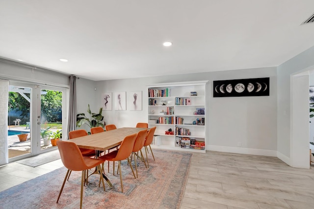 dining space with recessed lighting, light wood-type flooring, visible vents, and baseboards