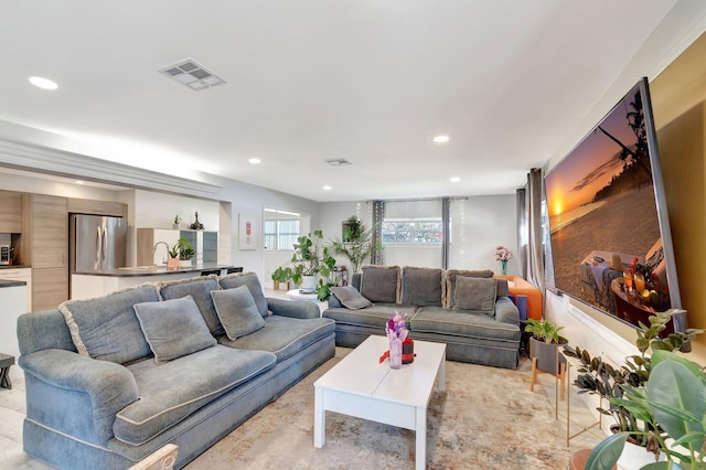 living area featuring recessed lighting and visible vents