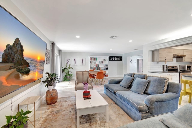 living area with visible vents and recessed lighting