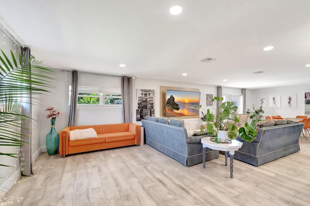 living area featuring recessed lighting, visible vents, and wood finished floors