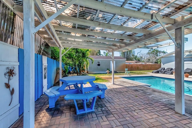 view of swimming pool featuring a patio area, fence, a fenced in pool, and a pergola