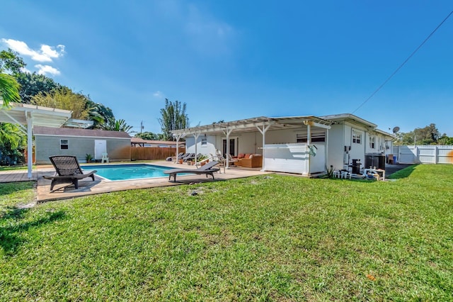 back of property featuring a fenced in pool, a fenced backyard, a lawn, and a pergola