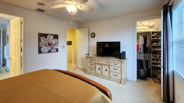 bedroom with light carpet, visible vents, ceiling fan, and a closet