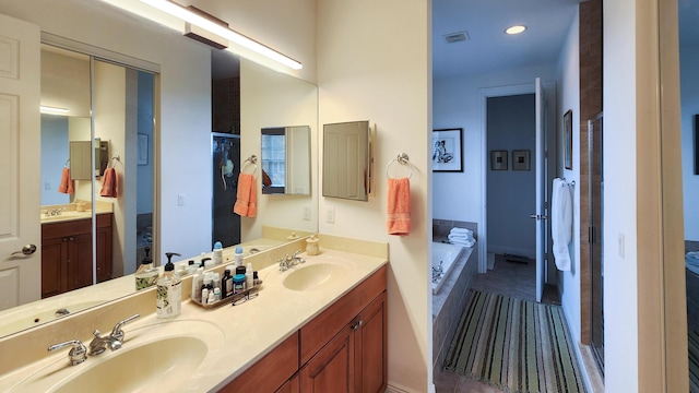 full bathroom featuring a bath, visible vents, and a sink