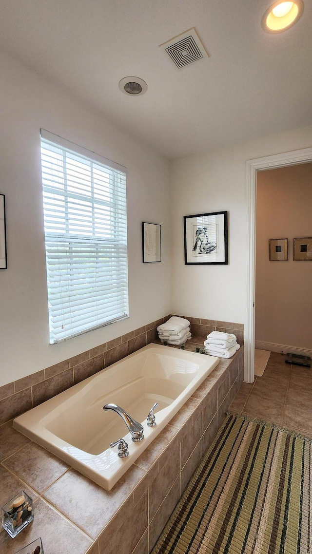 full bathroom with tile patterned flooring, visible vents, and a garden tub