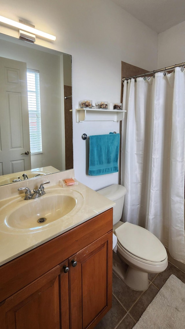 full bath with tile patterned floors, curtained shower, toilet, and vanity