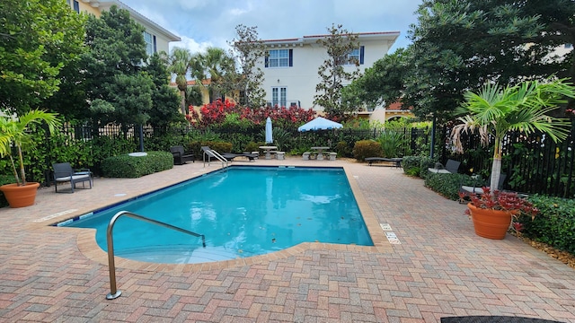 view of swimming pool with a patio area, a fenced in pool, and fence