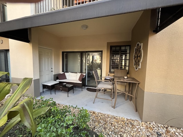 view of patio featuring outdoor lounge area and a balcony