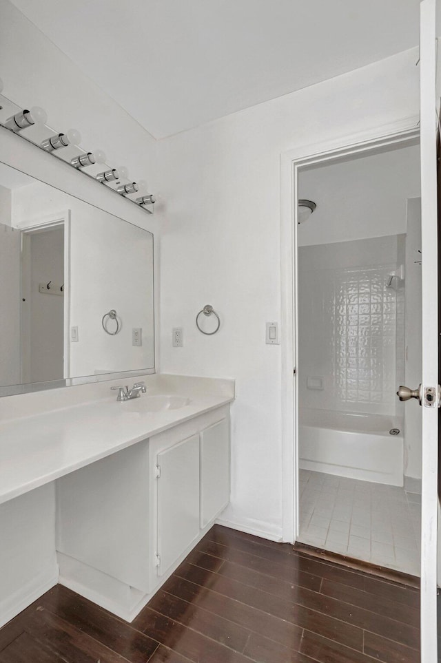 full bathroom featuring baseboards, vanity, shower / bathtub combination, and wood finished floors