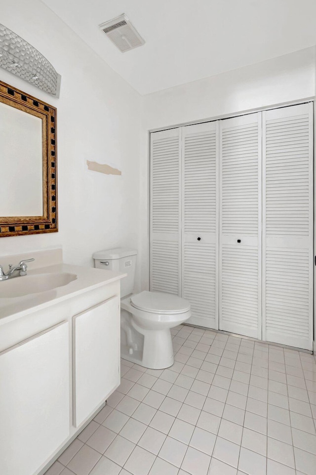 bathroom featuring a closet, visible vents, toilet, and tile patterned floors