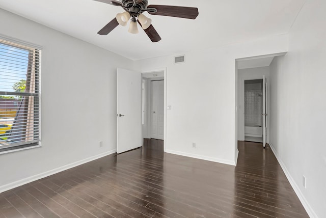 unfurnished bedroom featuring a ceiling fan, wood finished floors, visible vents, and baseboards