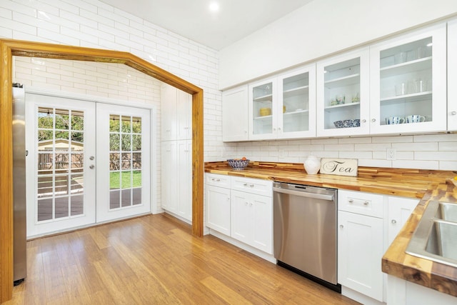 kitchen featuring white cabinetry, light wood-style flooring, butcher block countertops, and appliances with stainless steel finishes