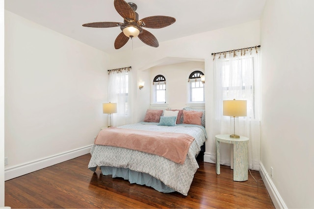 bedroom featuring wood finished floors, a ceiling fan, and baseboards