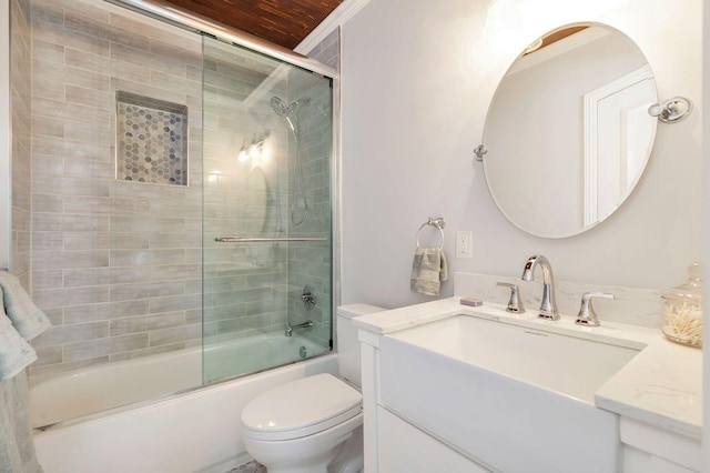 full bath featuring toilet, enclosed tub / shower combo, and vanity