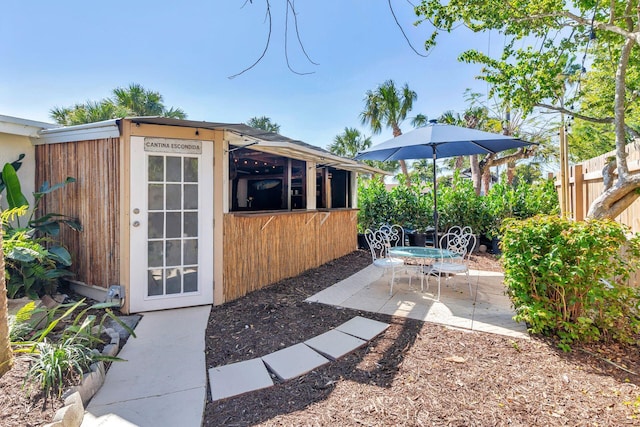 view of yard with a patio area, an outdoor structure, and fence