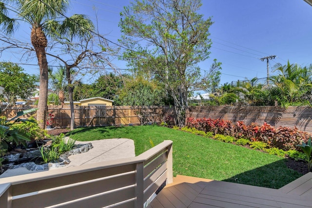 view of yard featuring fence and a wooden deck