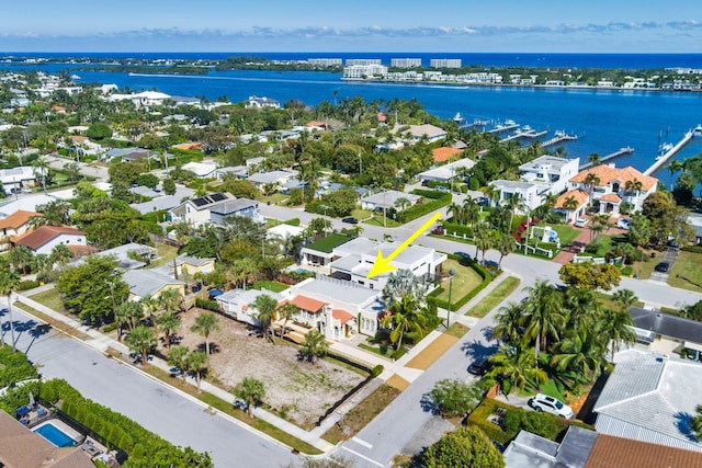 birds eye view of property with a water view and a residential view