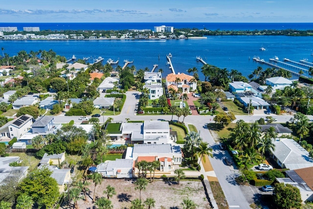 birds eye view of property with a water view and a residential view