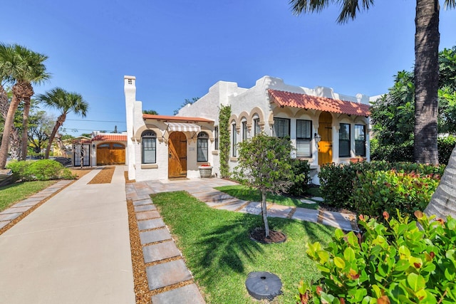 mediterranean / spanish-style home with a tile roof and stucco siding