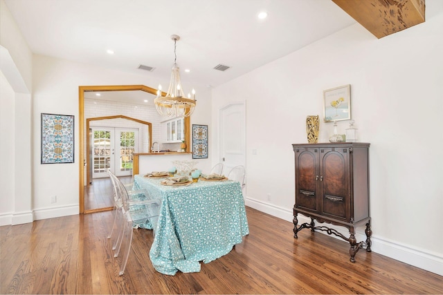 dining space with french doors, visible vents, baseboards, and wood finished floors