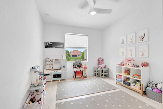 playroom with ceiling fan and wood finished floors