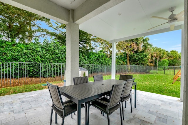 view of patio / terrace with ceiling fan, a fenced backyard, and outdoor dining space