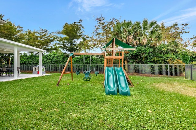 view of play area with a yard, a patio, and a fenced backyard