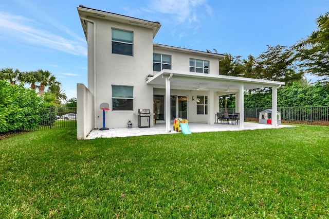 back of property with a patio area, a lawn, a fenced backyard, and ceiling fan