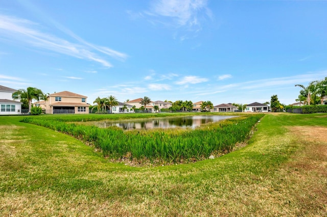 view of yard featuring a residential view and a water view