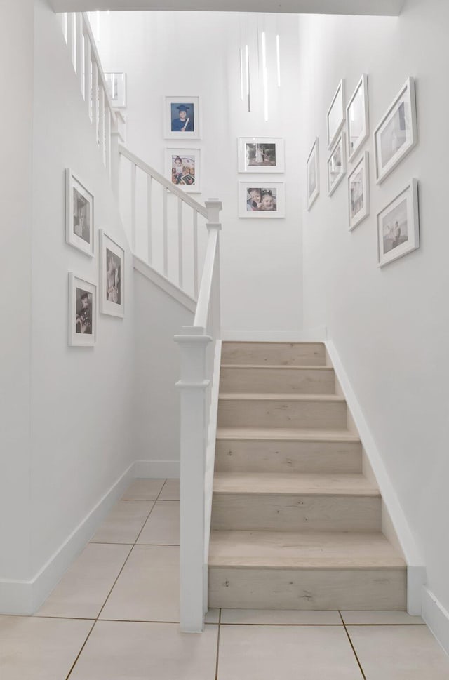 stairs with tile patterned flooring and baseboards