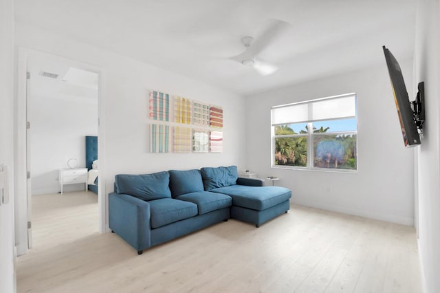 living area with light wood-style flooring and visible vents