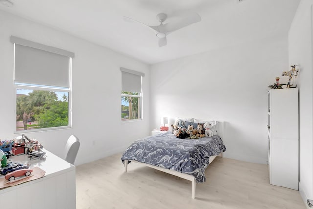 bedroom with a ceiling fan and light wood-style floors